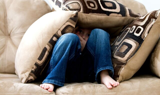 little boy, hiding, sad, child, fear, pillows, couch, pillow fort, bare feet, hide, hide and seek, brown fear, brown couch, sad, fear, fear, fear, fear, fear