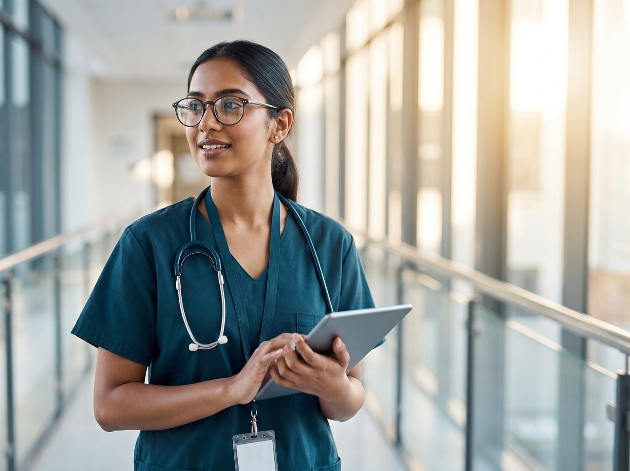 doctor, tablet, stethoscope, hospital, nurse, healthcare, clinic, scrubs, woman, glasses, professional, technology, smiling, confident, healthcare worker, modern, light, interior